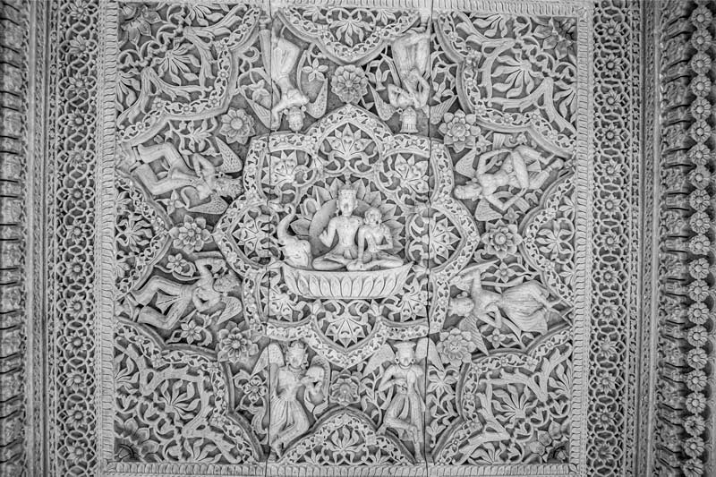 A ceiling panel inside a pavilion engraved with figures of Lord Vishnu and Goddess Lakshmi along with other celestial beings, amidst floral designs on Rajsamand embankment